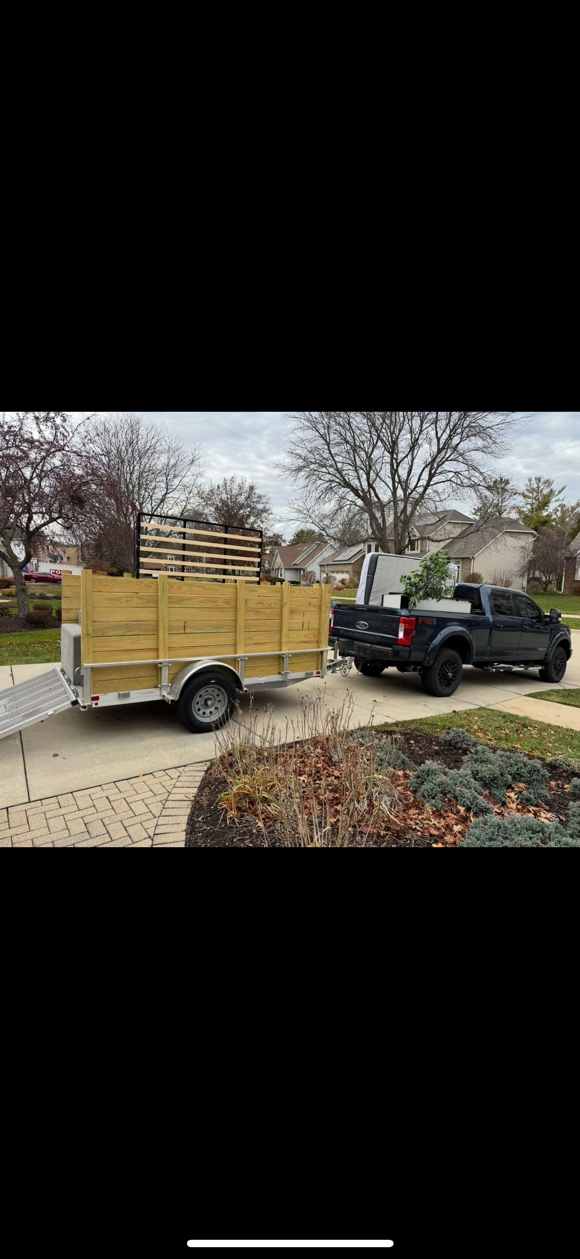 EZ Junk Hauling truck and trailer at residential pickup in Rockford IL
